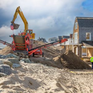 Crane Clearing out sand after disaster on beach