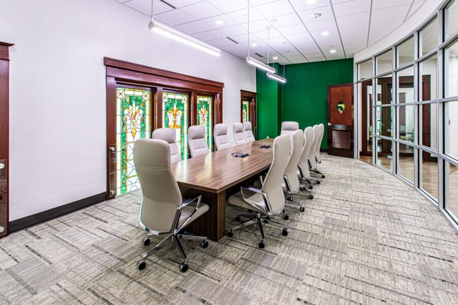 interior conference room with chairs around a large table surrounded by windows